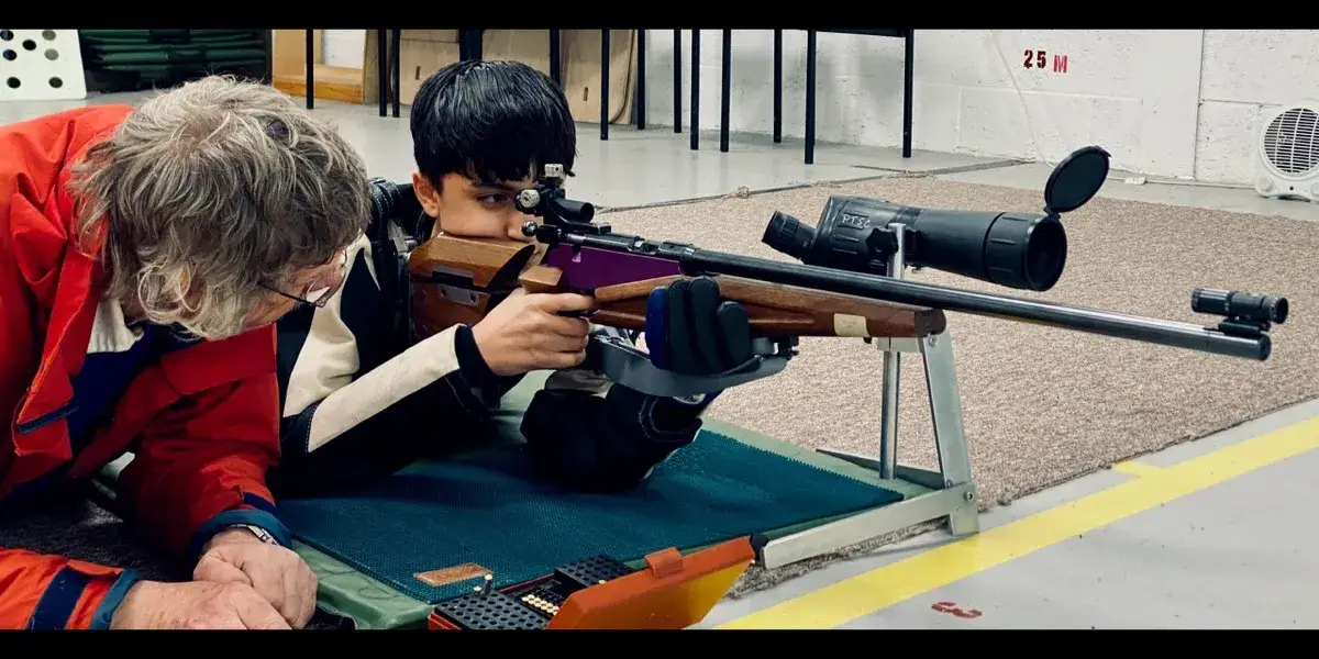 Beginner being coached at the firing line — Give it a Go session at Pinhoe TSC.