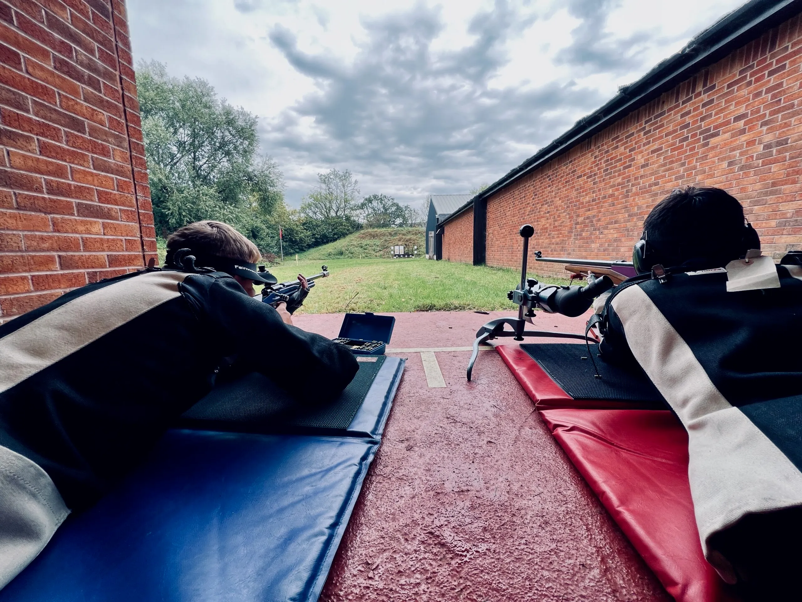 Prone rifle shooters on the firing line at the Pinhoe TSC outdoor 50m range.