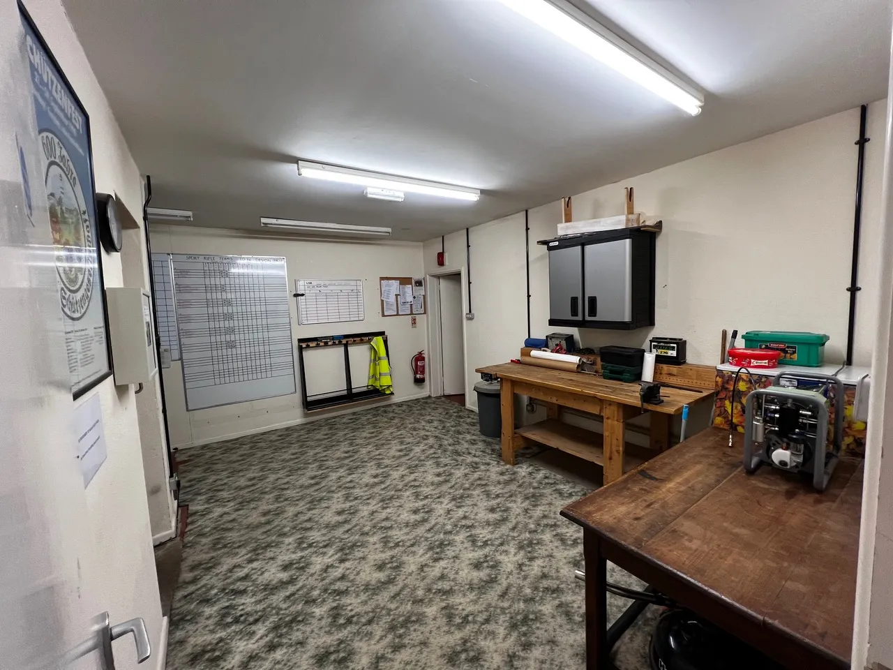 Workshop at Pinhoe TSC — benches, tools, and air compressor for charging air rifles and pistols.