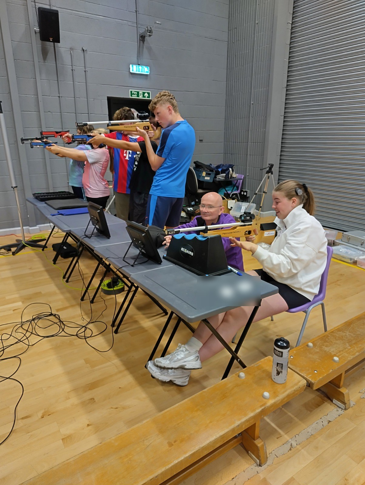 Rifles and pistols side by side on the laser range